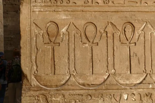 An antique wall with ankh signs and hieroglyphics-