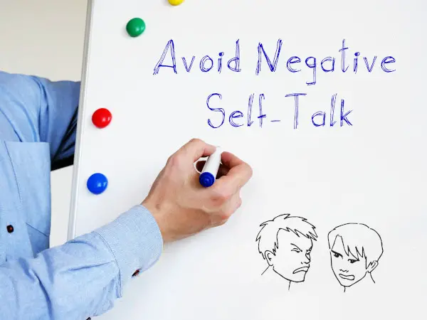 Avoid Negative Self-Talk phrase on the piece of paper.