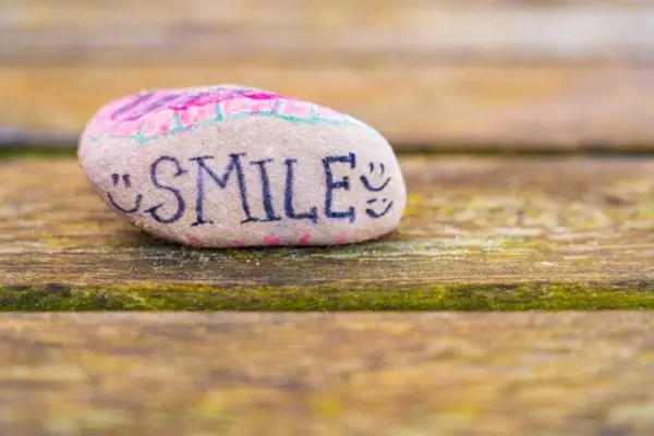 a stone with the writing "smile"