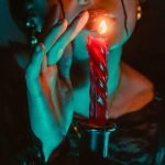 woman with a red candle - How Magic Adapted to a Rational World